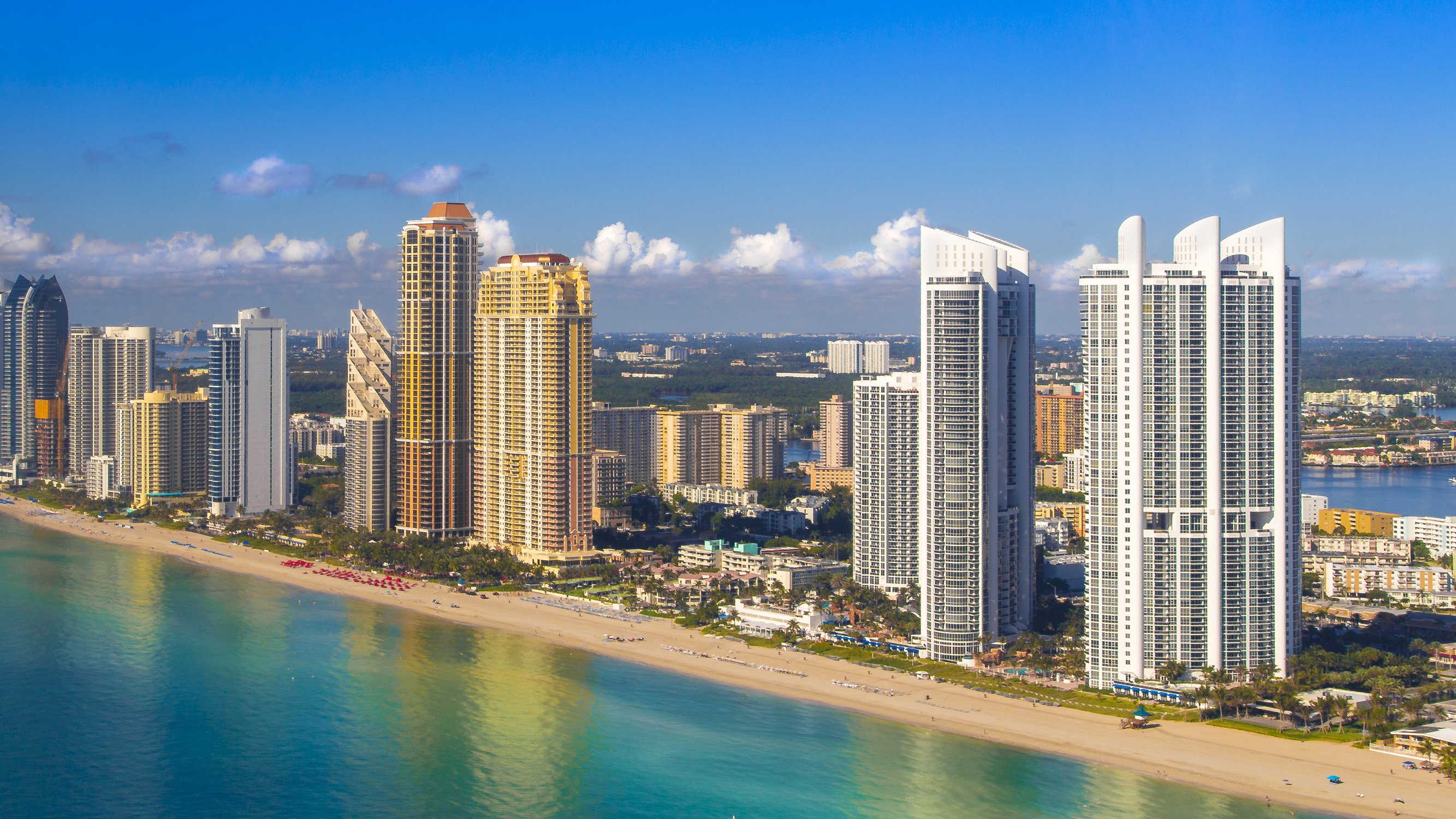 Sunny Isles Beach, Miami‑Dade skyline over sandy beach and Atlantic, prime corridor of luxury and ultra luxury condos; preconstruction and resale. Featuring coastal, city, and beachview.
