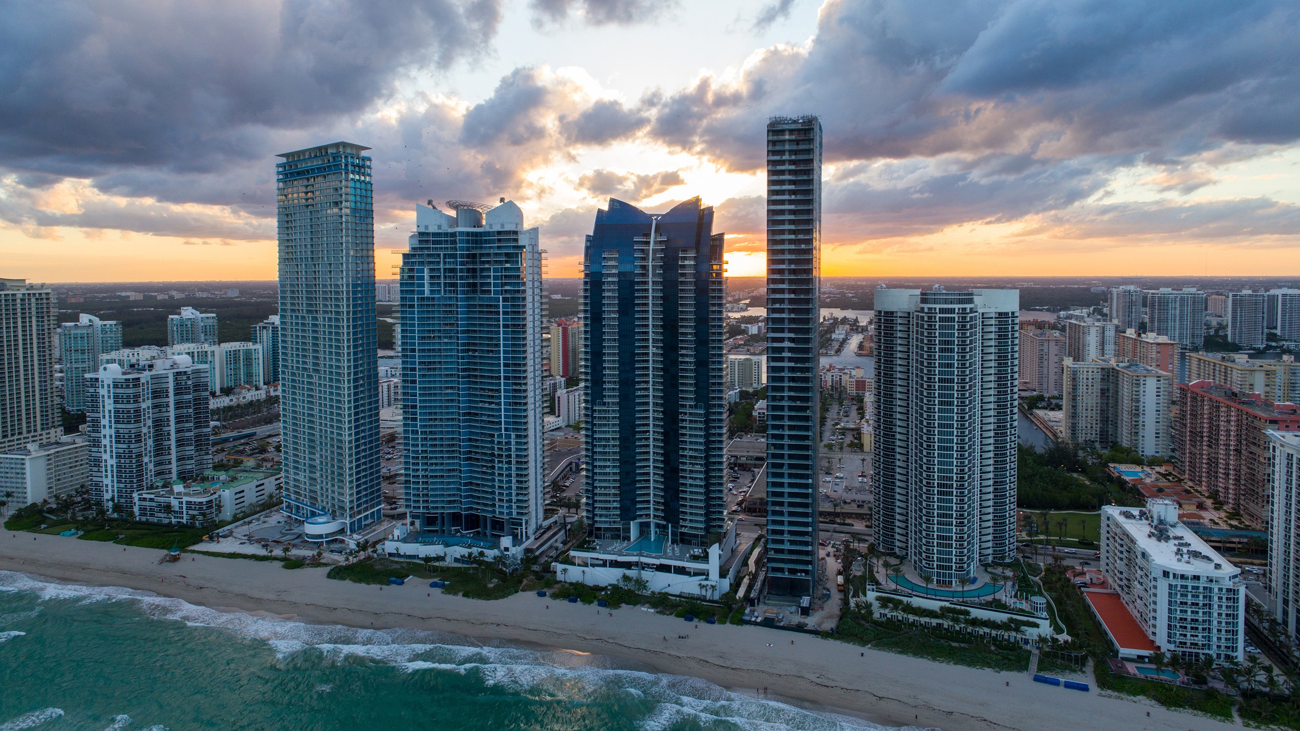 Sunny Isles Beach, Miami sunset cityscape with oceanfront towers, prime corridor for luxury and ultra luxury condos; preconstruction and resale.