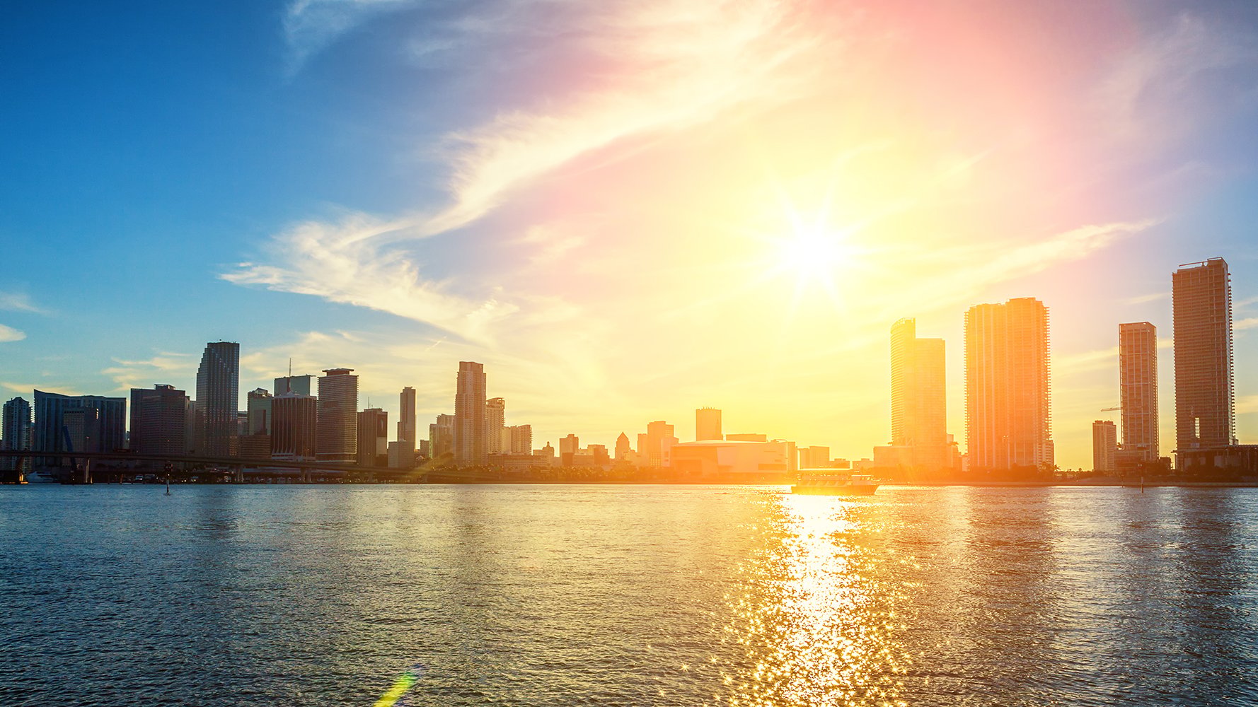 Miami, Florida sunset skyline reflected on Biscayne Bay—central hub for luxury and ultra luxury condos; preconstruction and resale.