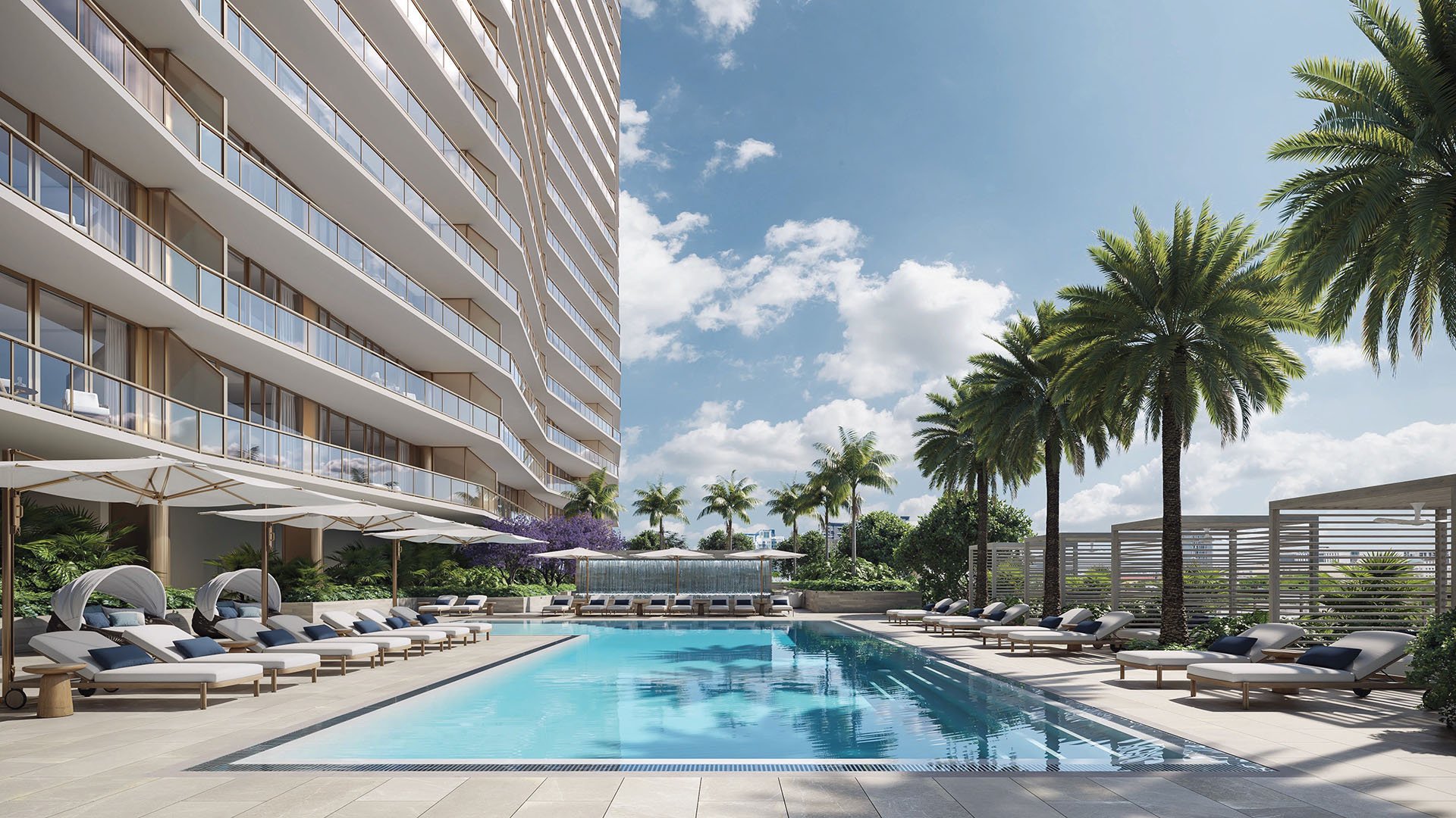 Palm-lined courtyard resort pool with loungers and cabanas beside the curving tower at The Berkeley in West Palm Beach, showcasing luxury and ultra luxury condos with a private amenity sundeck.
