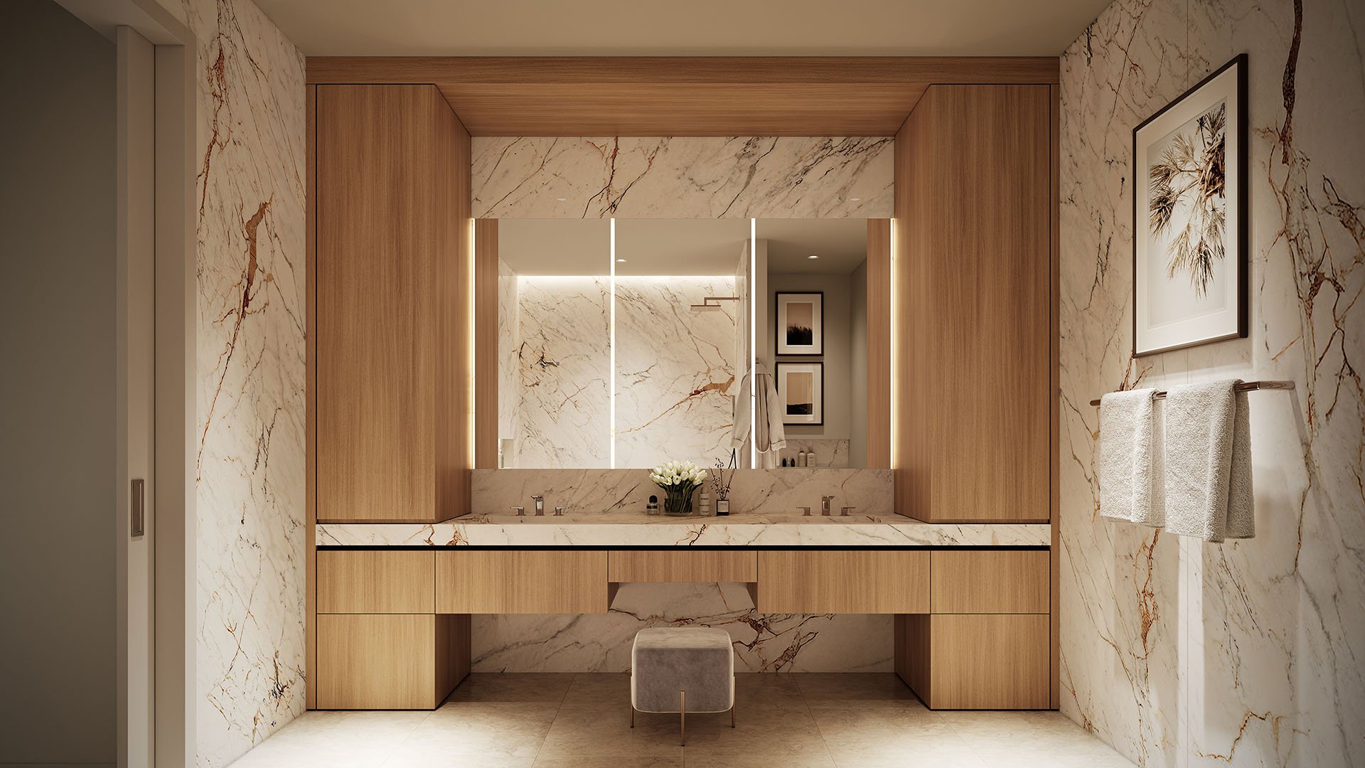 Marble ensuite vanity with warm wood millwork, integrated lighting, and a tailored double sink layout at The Berkeley in West Palm Beach, showcasing luxury and ultra luxury condos with spa-inspired bath design.