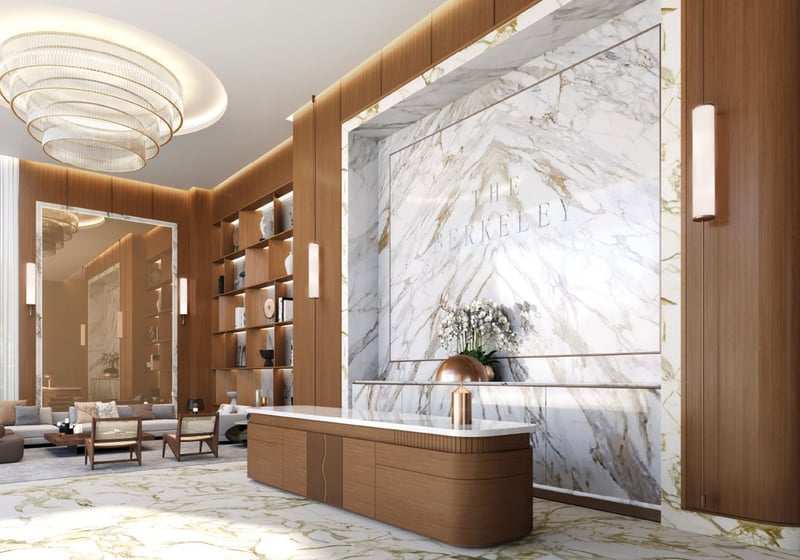 Reception lobby with a marble feature wall, concierge desk, and lounge seating at The Berkeley in West Palm Beach, reflecting luxury and ultra luxury condos with a polished welcome experience.