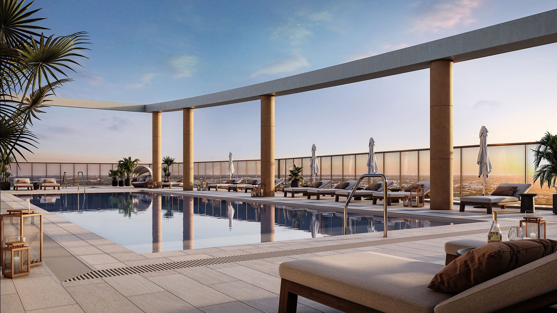 Rooftop pool terrace with a nest daybed, loungers, and skyline views at The Berkeley in West Palm Beach, showcasing luxury and ultra luxury condos with resort-style outdoor amenities.