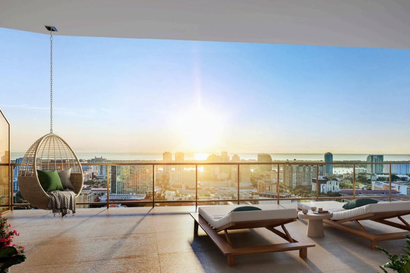 Open-air terrace with a hanging chair, sun loungers, and skyline views at The Berkeley in West Palm Beach, highlighting luxury and ultra luxury condos with expansive outdoor lounge space.