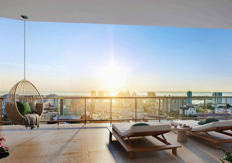 Open-air terrace with a hanging chair, sun loungers, and skyline views at The Berkeley in West Palm Beach, highlighting luxury and ultra luxury condos with expansive outdoor lounge space.