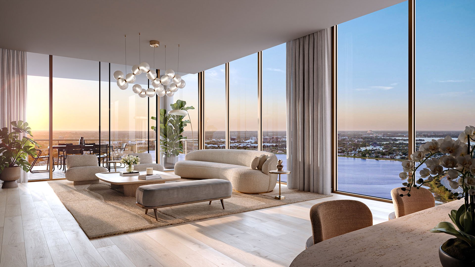 Sunlit living room with a designer chandelier, full-height glass, and water views at The Berkeley in West Palm Beach, showcasing luxury and ultra luxury condos with elegant open-plan living.