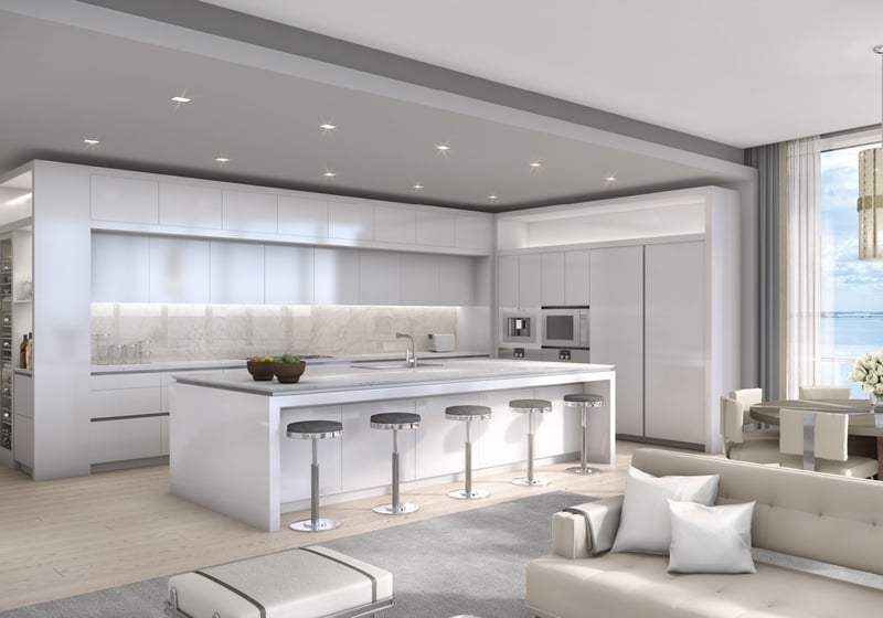 Open chef kitchen with an oversized island, custom cabinetry, and water views at The Bristol Palm Beach in Palm Beach, reflecting luxury and ultra luxury condos interior design.