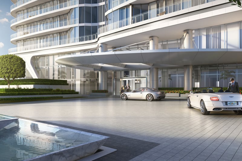 Curved condo exterior with a covered arrival drive and porte cochere entrance at The Bristol Palm Beach in Palm Beach, presenting the luxury and ultra luxury condos arrival experience.