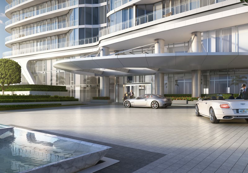 Curved condo exterior with a covered arrival drive and porte cochere entrance at The Bristol Palm Beach in Palm Beach, presenting the luxury and ultra luxury condos arrival experience.