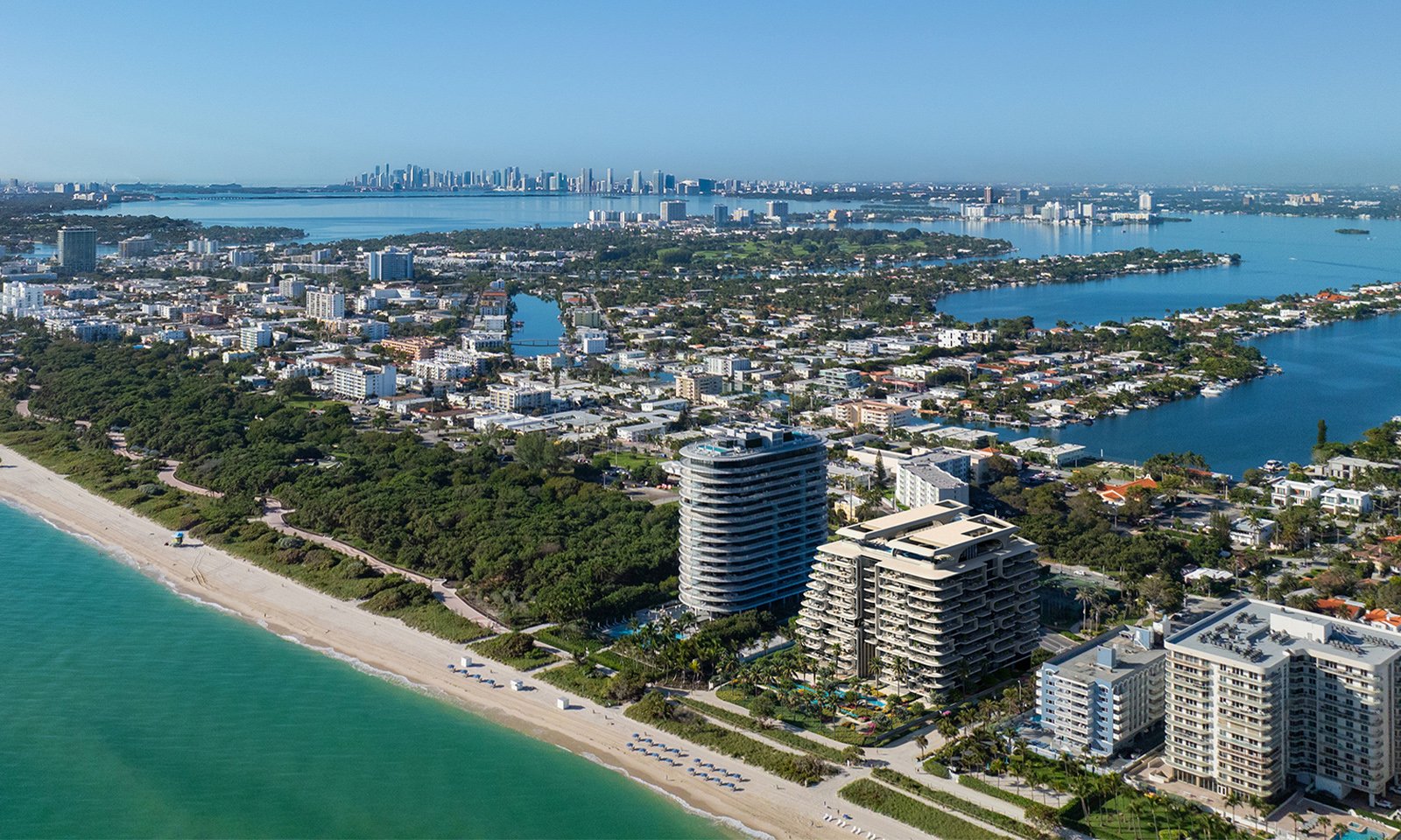 The Delmore, Surfside Miami aerial over coastal cityscape, oceanfront site of ultra luxury and luxury condos; preconstruction. Featuring view.