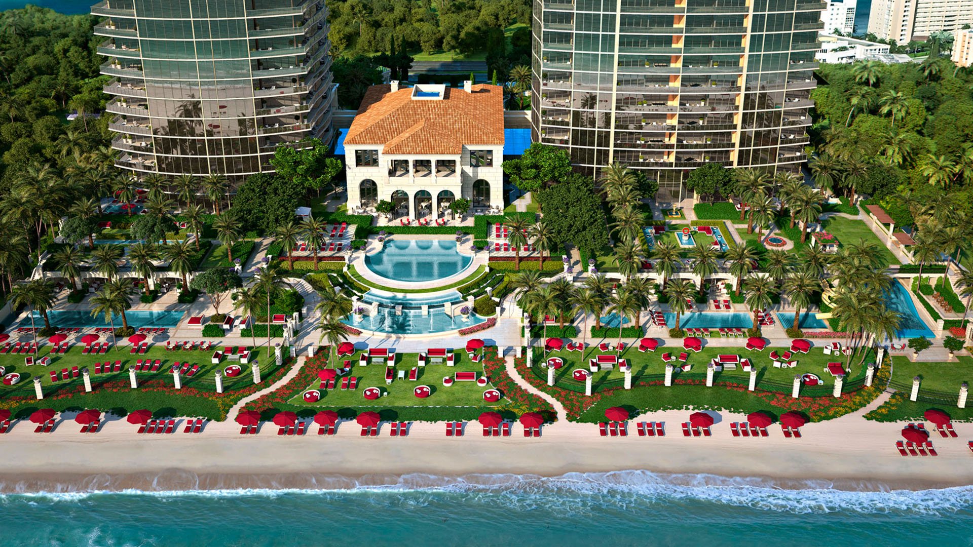 Aerial beachfront view of the towers, central lawn, and pool deck at The Estates at Acqualina, Sunny Isles Beach, a community of luxury and ultra luxury condos.