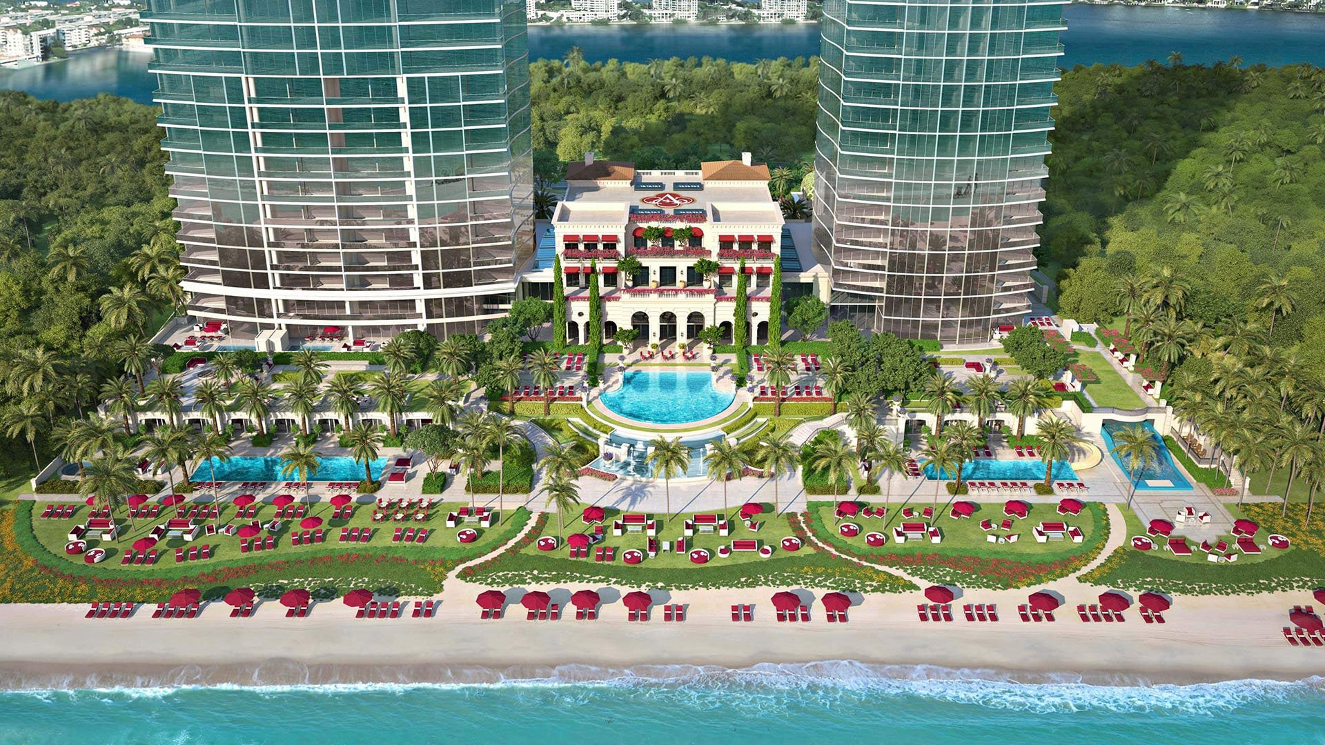 Aerial waterfront view of twin towers, beachfront gardens, and the central pool at The Estates at Acqualina, Sunny Isles Beach, a community of luxury and ultra luxury condos.