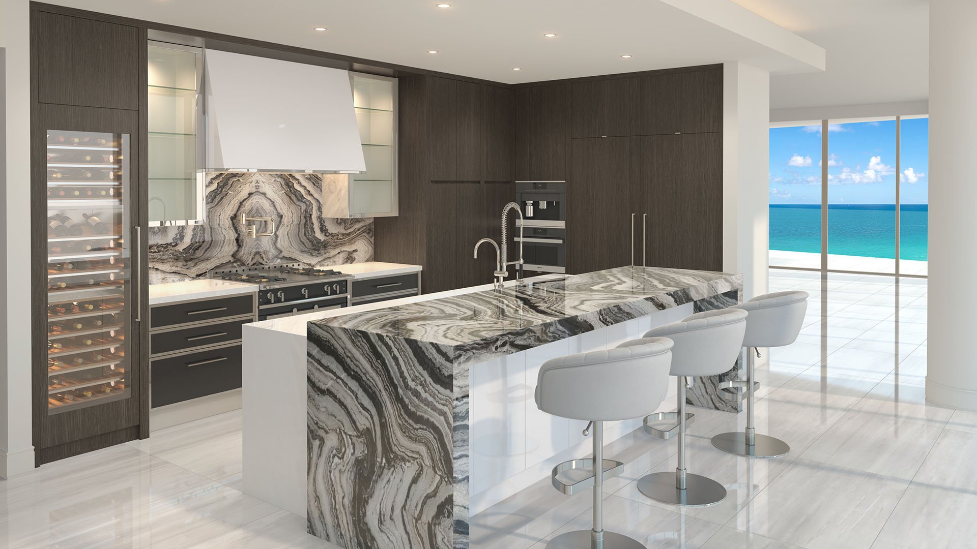 Gourmet kitchen with a marbled island, wine wall, and ocean-view terrace at The Estates at Acqualina, Sunny Isles Beach, a community of luxury and ultra luxury condos.