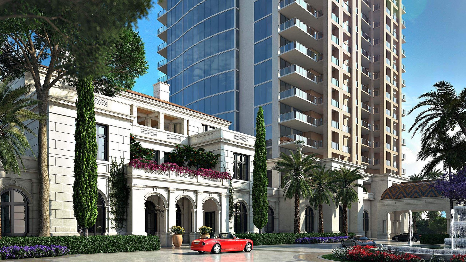 Grand porte cochere and tower entrance with palm-lined landscaping at The Estates at Acqualina, Sunny Isles Beach, a community of luxury and ultra luxury condos.
