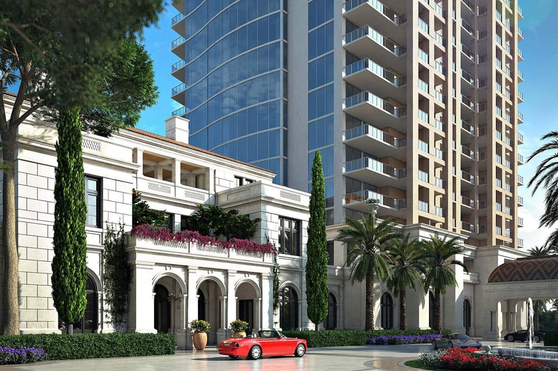 Grand porte cochere and tower entrance with palm-lined landscaping at The Estates at Acqualina, Sunny Isles Beach, a community of luxury and ultra luxury condos.