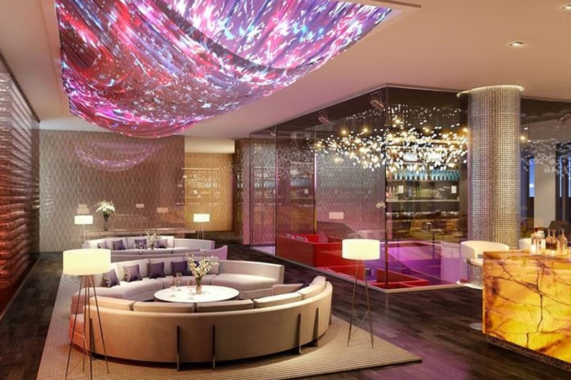 Lobby lounge with a dramatic ceiling installation, round seating, and warm lighting at The Estates at Acqualina, Sunny Isles Beach, a community of luxury and ultra luxury condos.