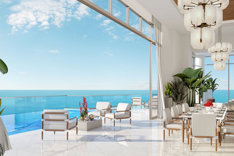 Oceanfront dining lounge opening to a terrace pool and horizon views at The Estates at Acqualina, Sunny Isles Beach, a community of luxury and ultra luxury condos.