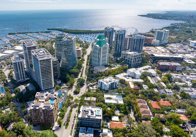 Aerial view of Coconut Grove, Miami, Florida and Biscayne Bay marinas with sailboats, near The Lincoln luxury and ultra luxury preconstruction condos, highlighting waterfront cityscape, yacht harbor and coastal lifestyle.