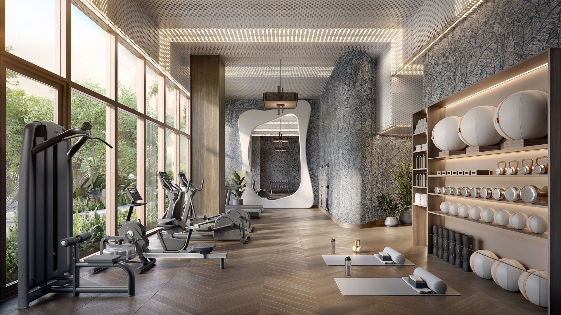 Wellness center at The Lincoln Coconut Grove, Miami, Florida featuring cardio machines, strength equipment, yoga mats and wall-mounted fitness gear, showcasing luxury and ultra luxury preconstruction condos amenities with floor-to-ceiling windows and serene garden views.