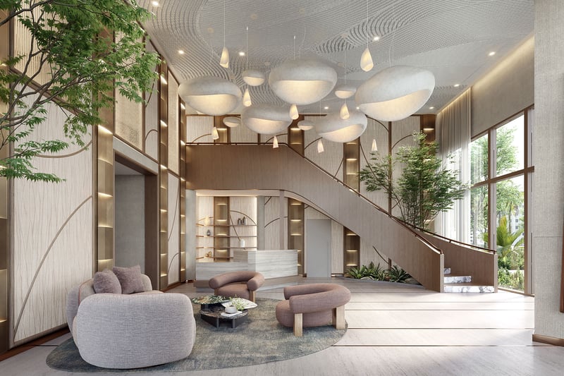 Double-height lobby at The Lincoln Coconut Grove, Miami, Florida with grand staircase, sculptural pendant lights and resident lounge seating, defining luxury and ultra luxury preconstruction condos arrival experience with concierge-style desk, warm wood finishes and greenery.