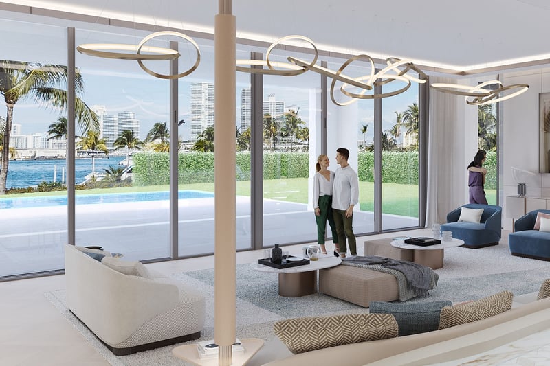 The Links Estates, Fisher Island, Miami Beach, Florida living room with floor-to-ceiling glass, waterfront Miami skyline view, ring chandelier and blue lounge chairs, featuring luxury and ultra luxury preconstruction condos.