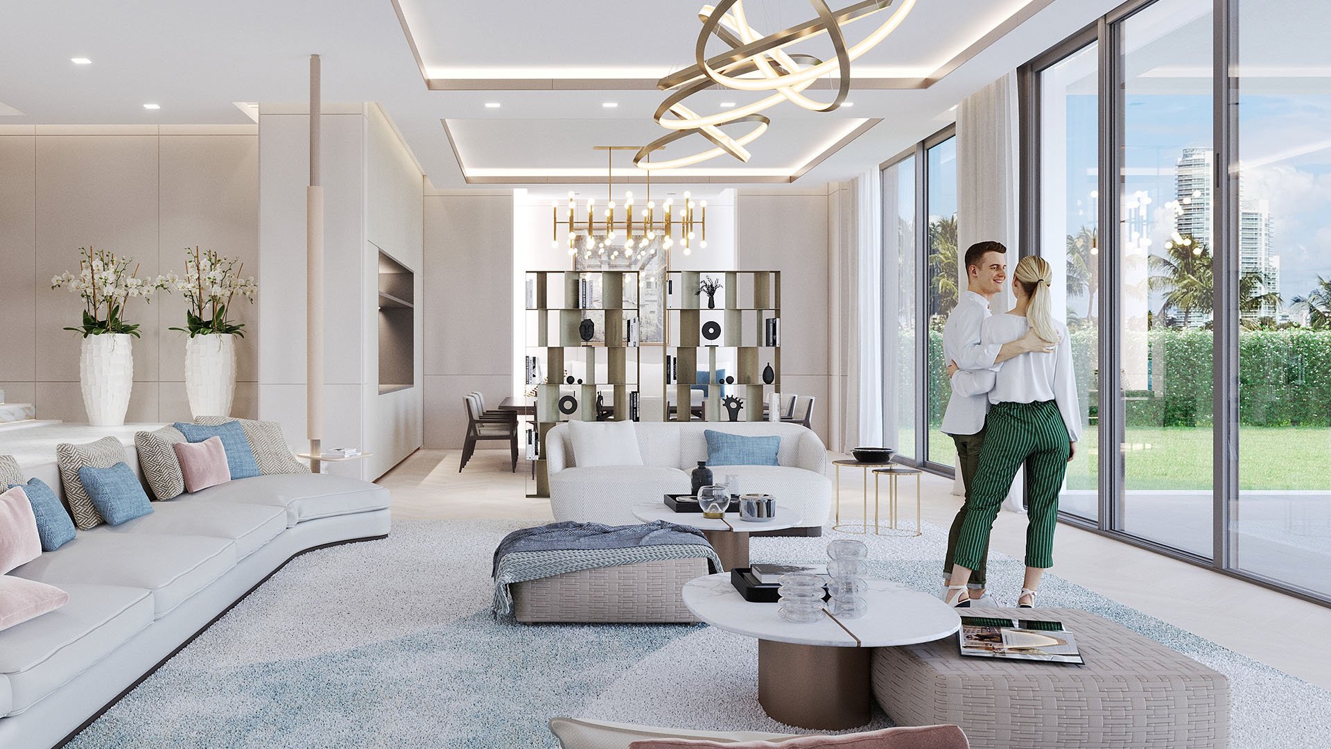 The Links Estates, Fisher Island, Miami Beach, Florida daylight open-plan living room with curved sectional, dining table, wall-to-wall windows and ring chandelier, showcasing luxury and ultra luxury preconstruction condos.
