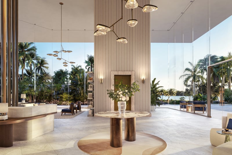 The Perigon Miami Beach lobby with palm trees, sculptural lines and natural light, oceanfront entrance for luxury and ultra luxury condos in Miami Beach; preconstruction. Featuring modern interior.