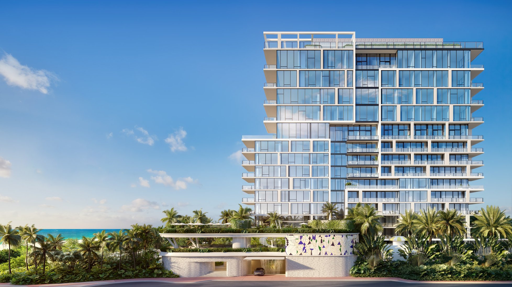 Oceanfront modern condominium tower on The Raleigh in Miami Beach with expansive glass façades, large terraces, lush tropical landscaping, and direct beach views, showcasing contemporary luxury coastal living. Featuring condo and building.
