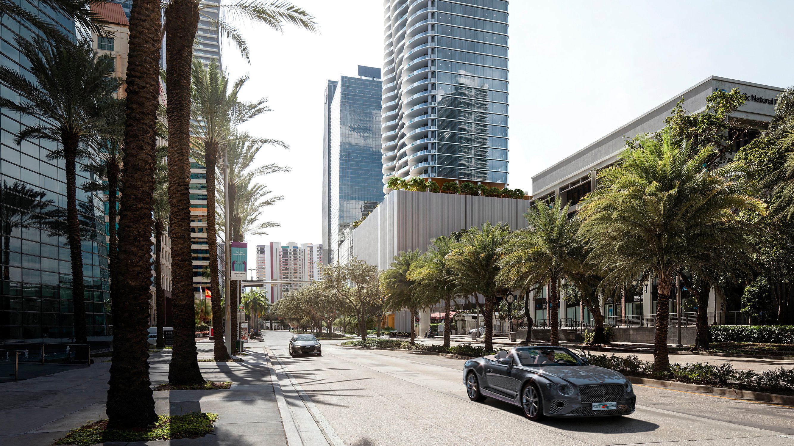 The Residences at 1428 Brickell urban street scene with modern towers and palms. Brickell, Miami; coveted address for luxury and ultra luxury condos; preconstruction. Featuring buildings and palm trees.