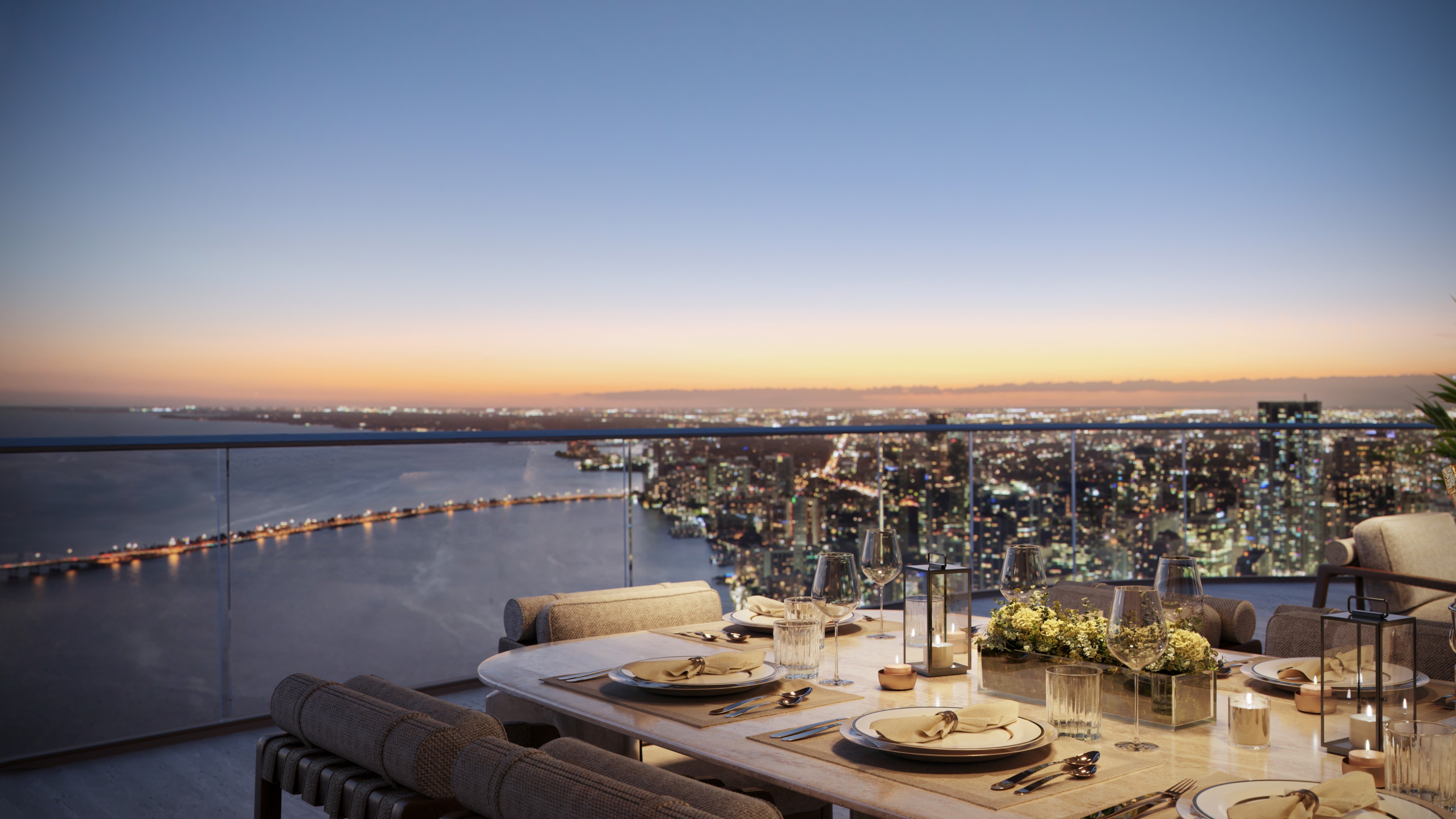 The Residences at Mandarin Oriental, Miami dinner with skyline at sunset. Brickell Key; elevated lifestyle in luxury and ultra luxury condos; preconstruction. Featuring elegant, city, and view.