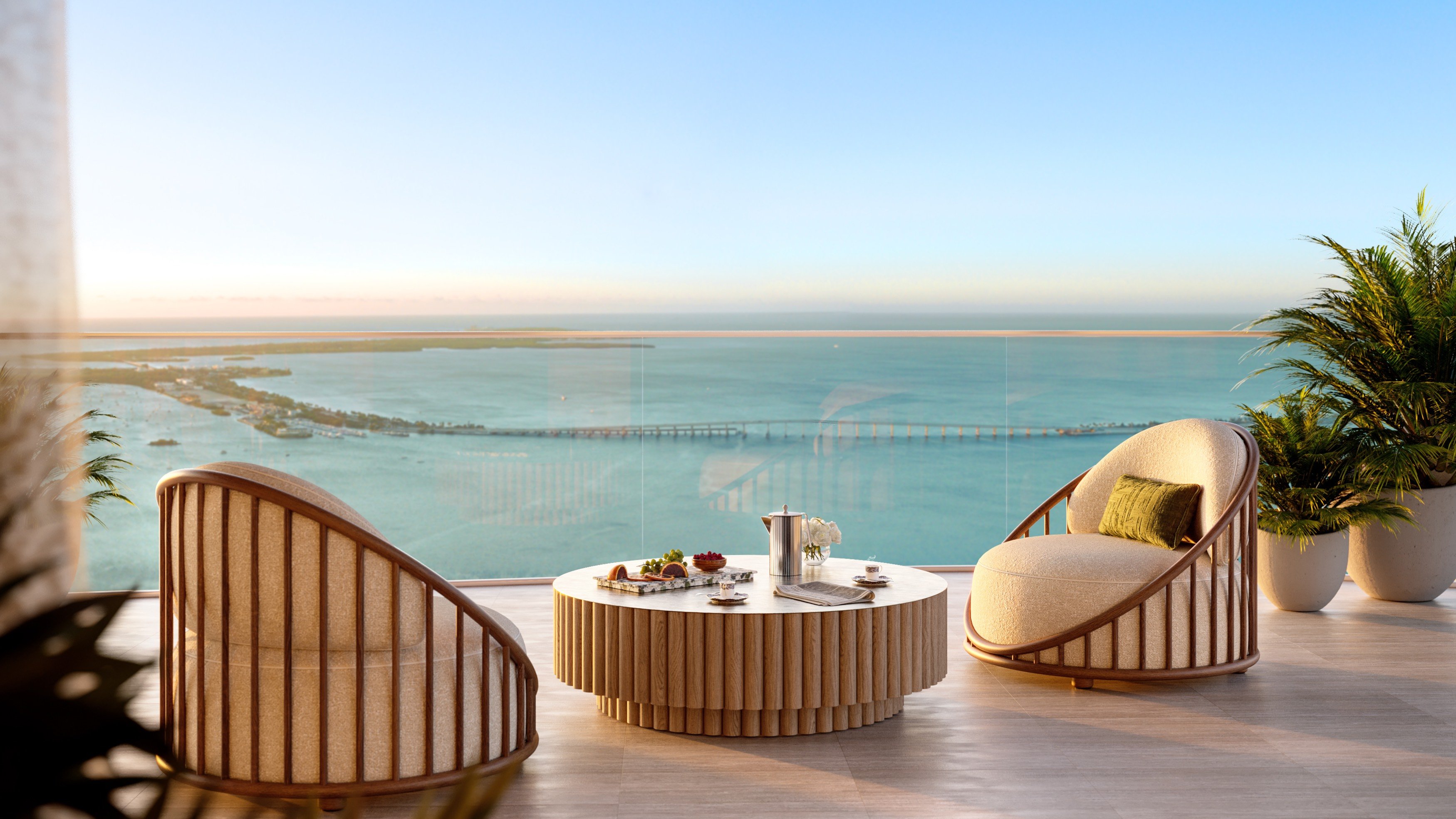 The Residences at Mandarin Oriental, Brickell Key Miami balcony tea setting with skyline, elevated lifestyle in luxury and ultra luxury condos; preconstruction. Featuring modern and view.