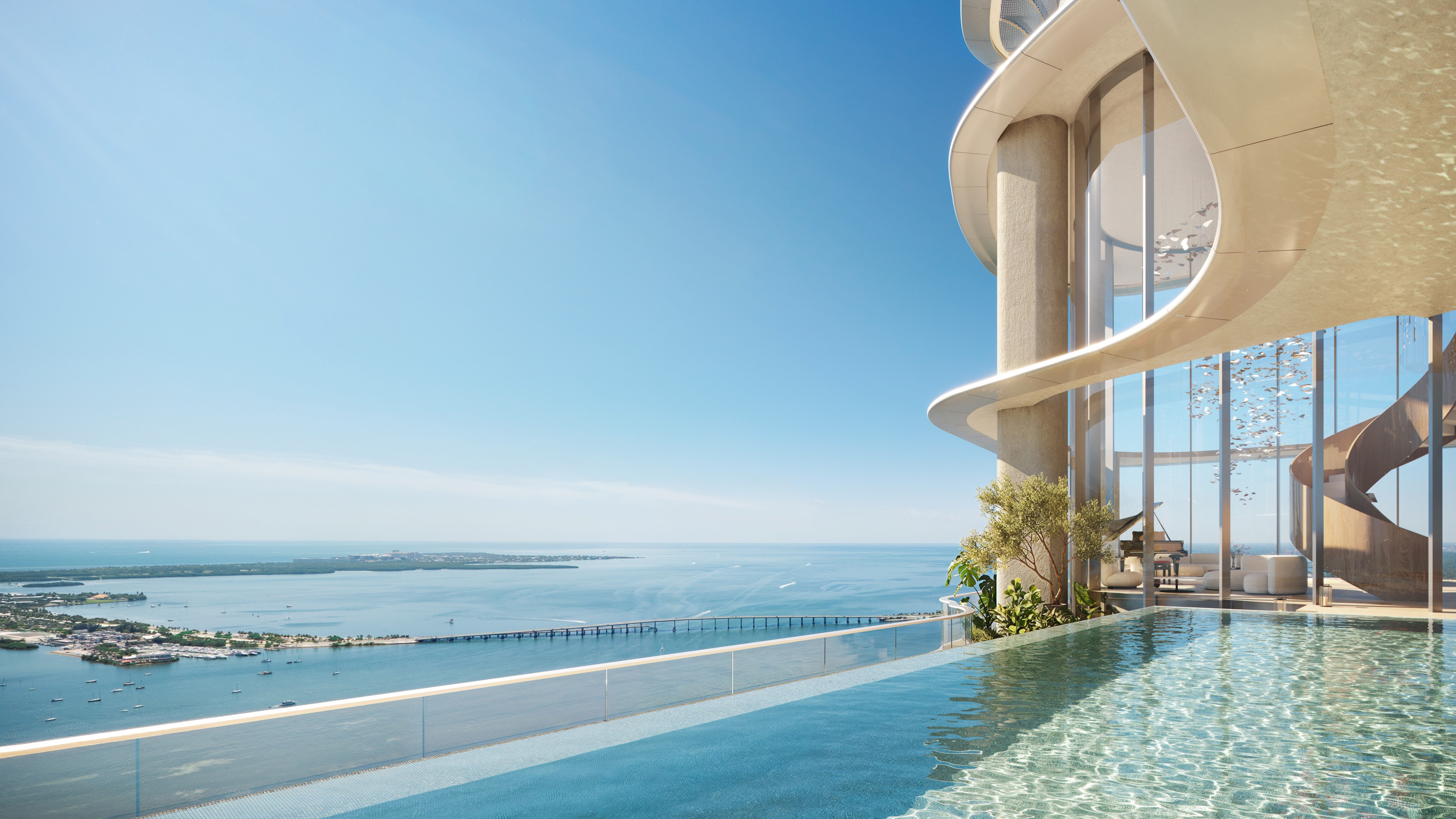 Infinity pool overlooking skyline and bay at The Residences at Mandarin Oriental, Miami Tower Two; luxury resort-style amenity for ultra luxury preconstruction condos. Featuring view and mountains.