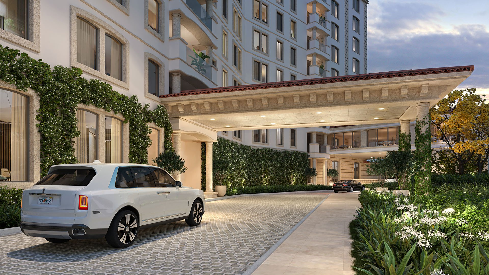Porte cochere arrival at The Residences at Six Fisher Island, Fisher Island Miami Beach, Florida, featuring valet drop-off and covered driveway with lush landscaping, representing luxury and ultra luxury preconstruction condos.