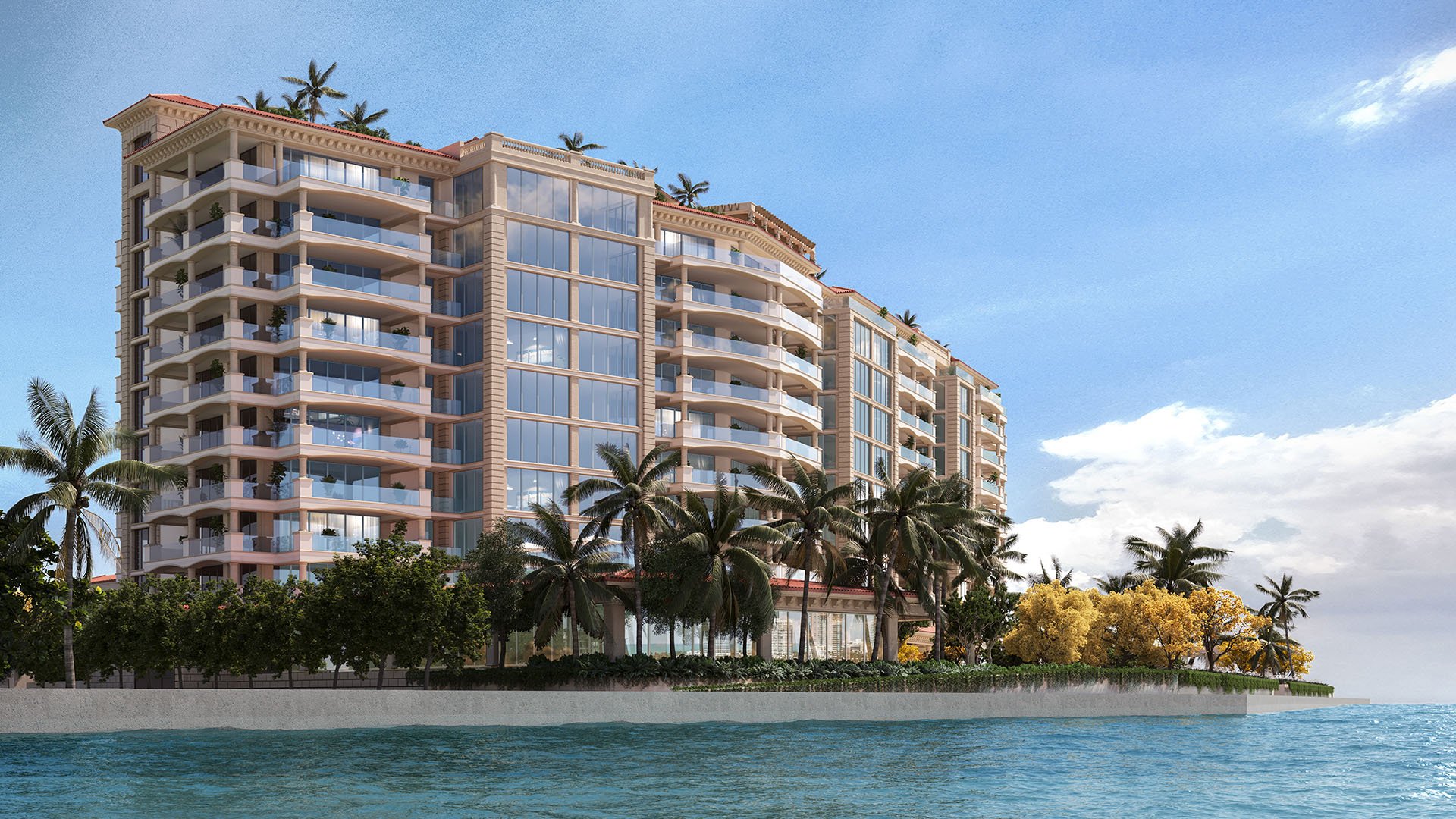 Waterfront exterior of The Residences at Six Fisher Island, Fisher Island Miami Beach, Florida, viewed from the Intracoastal Waterway with expansive glass balconies and palm-lined shoreline, featuring luxury and ultra luxury preconstruction condos.