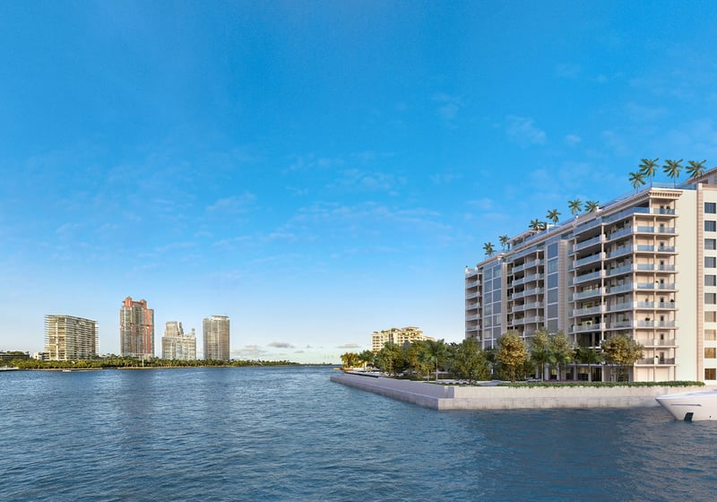 East elevation waterfront hero of The Residences at Six Fisher Island, Fisher Island Miami Beach, Florida, with private yacht at the dock and Miami skyline across the bay, presenting luxury and ultra luxury preconstruction condos.