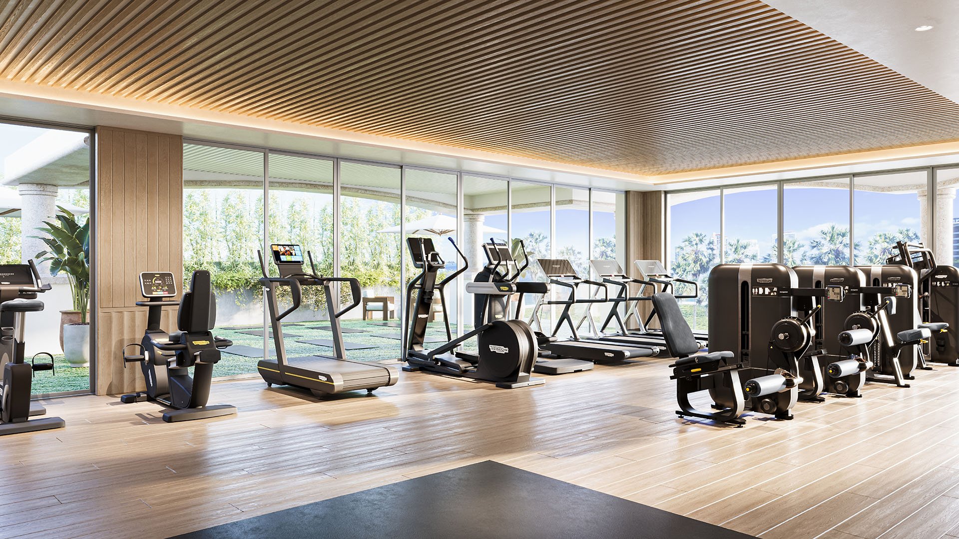 Fitness and yoga studio at The Residences at Six Fisher Island, Fisher Island Miami Beach, Florida, featuring treadmills and cardio equipment under a wood slat ceiling with ocean and bay views, part of luxury and ultra luxury preconstruction condos amenities.
