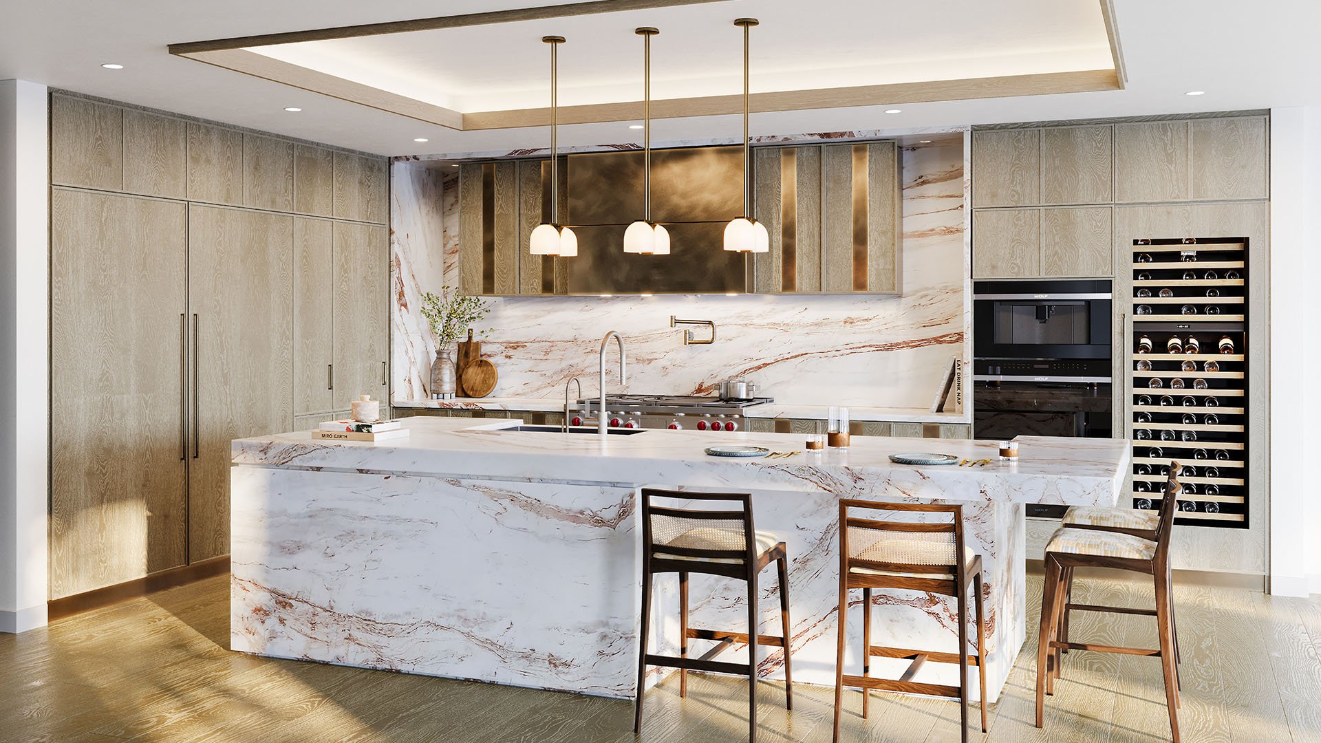 Gourmet kitchen in The Residences at Six Fisher Island, Fisher Island Miami Beach, Florida, with dramatic veined marble waterfall island, designer pendants and wine wall, reflecting luxury and ultra luxury preconstruction condos interiors.