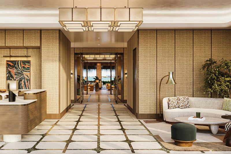 Grand lobby and reception at The Residences at Six Fisher Island, Fisher Island Miami Beach, Florida, featuring designer chandelier, concierge desk and lounge seating, setting the tone for luxury and ultra luxury preconstruction condos.