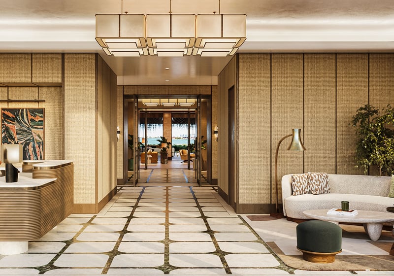 Grand lobby and reception at The Residences at Six Fisher Island, Fisher Island Miami Beach, Florida, featuring designer chandelier, concierge desk and lounge seating, setting the tone for luxury and ultra luxury preconstruction condos.