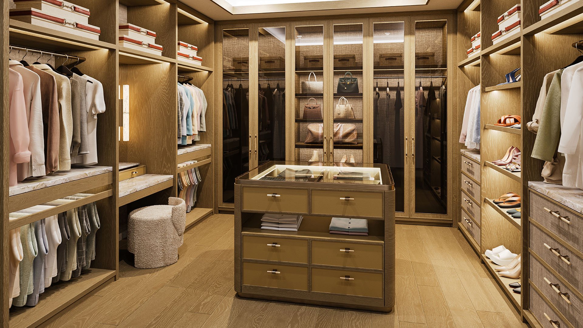 Primary wardrobe walk-in closet at The Residences at Six Fisher Island, Fisher Island Miami Beach, Florida, with custom millwork, shoe shelving and drawer island, showcasing luxury and ultra luxury preconstruction condos interior design.