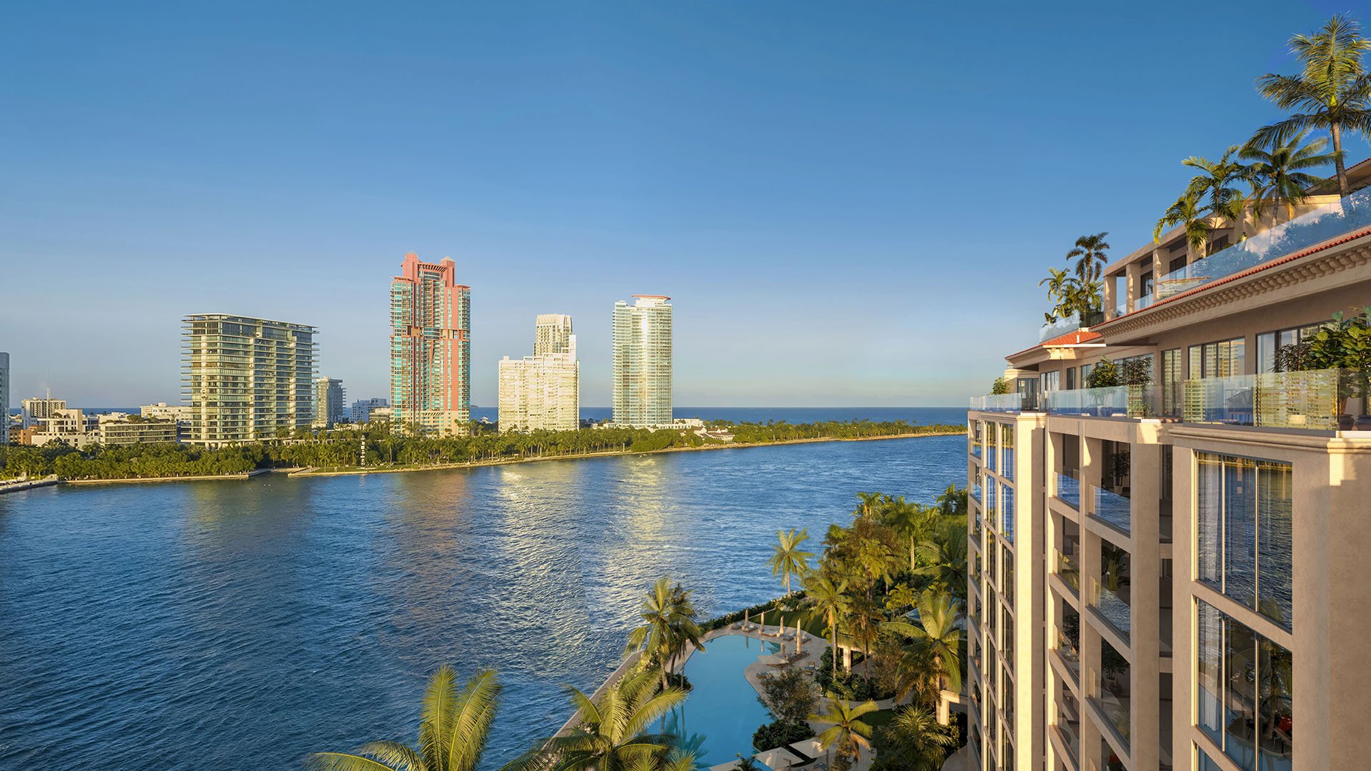 Hummingbird residence balcony view at The Residences at Six Fisher Island, Fisher Island Miami Beach Florida, overlooking Biscayne Bay and skyline; luxury and ultra luxury preconstruction condos with waterfront pool below.