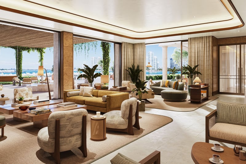 Open-plan living room with multiple seating areas and wide glass openings to Biscayne Bay at The Residences at Six Fisher Island, Fisher Island Miami Beach Florida; luxury and ultra luxury preconstruction condos.