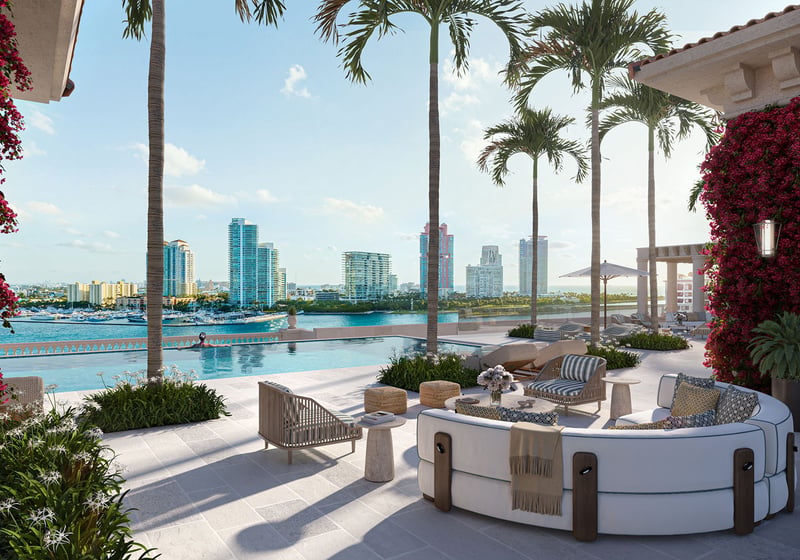 Penthouse terrace pool at The Residences at Six Fisher Island, Fisher Island Miami Beach Florida, with palms and bougainvillea framing Miami skyline and waterfront; luxury and ultra luxury preconstruction condos outdoor amenity.