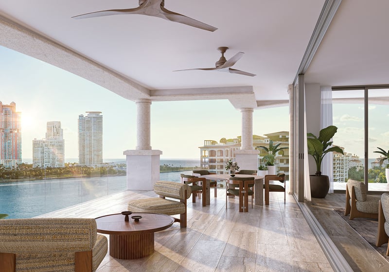 Residence 01 covered balcony dining at The Residences at Six Fisher Island, Fisher Island Miami Beach Florida, ceiling fans and sunset waterfront view; luxury and ultra luxury preconstruction condos with expansive terraces.