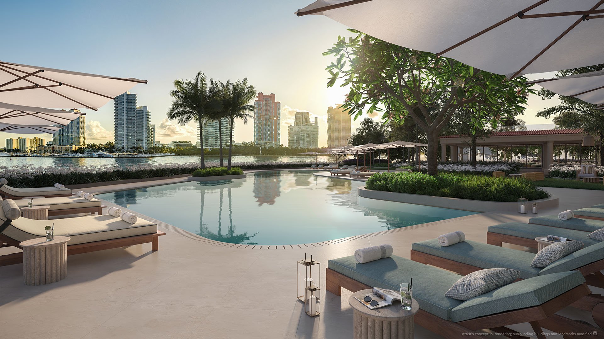 South pool at The Residences at Six Fisher Island, Fisher Island Miami Beach Florida, waterfront resort-style pool with cabanas, loungers and umbrellas facing skyline; luxury and ultra luxury preconstruction condos amenities.