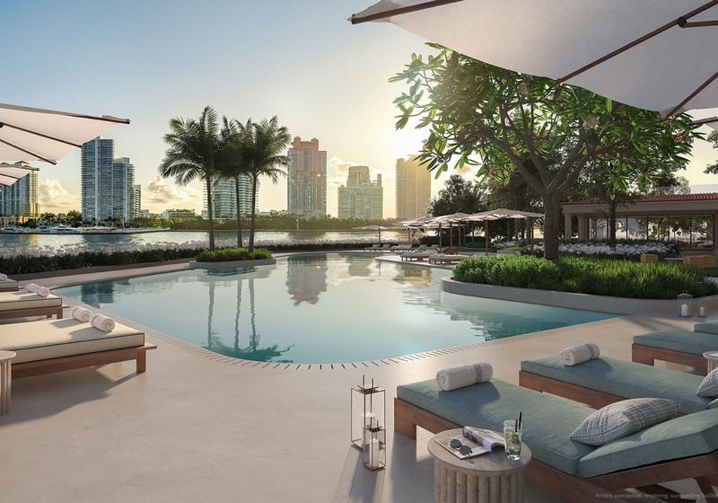 South pool at The Residences at Six Fisher Island, Fisher Island Miami Beach Florida, waterfront resort-style pool with cabanas, loungers and umbrellas facing skyline; luxury and ultra luxury preconstruction condos amenities.