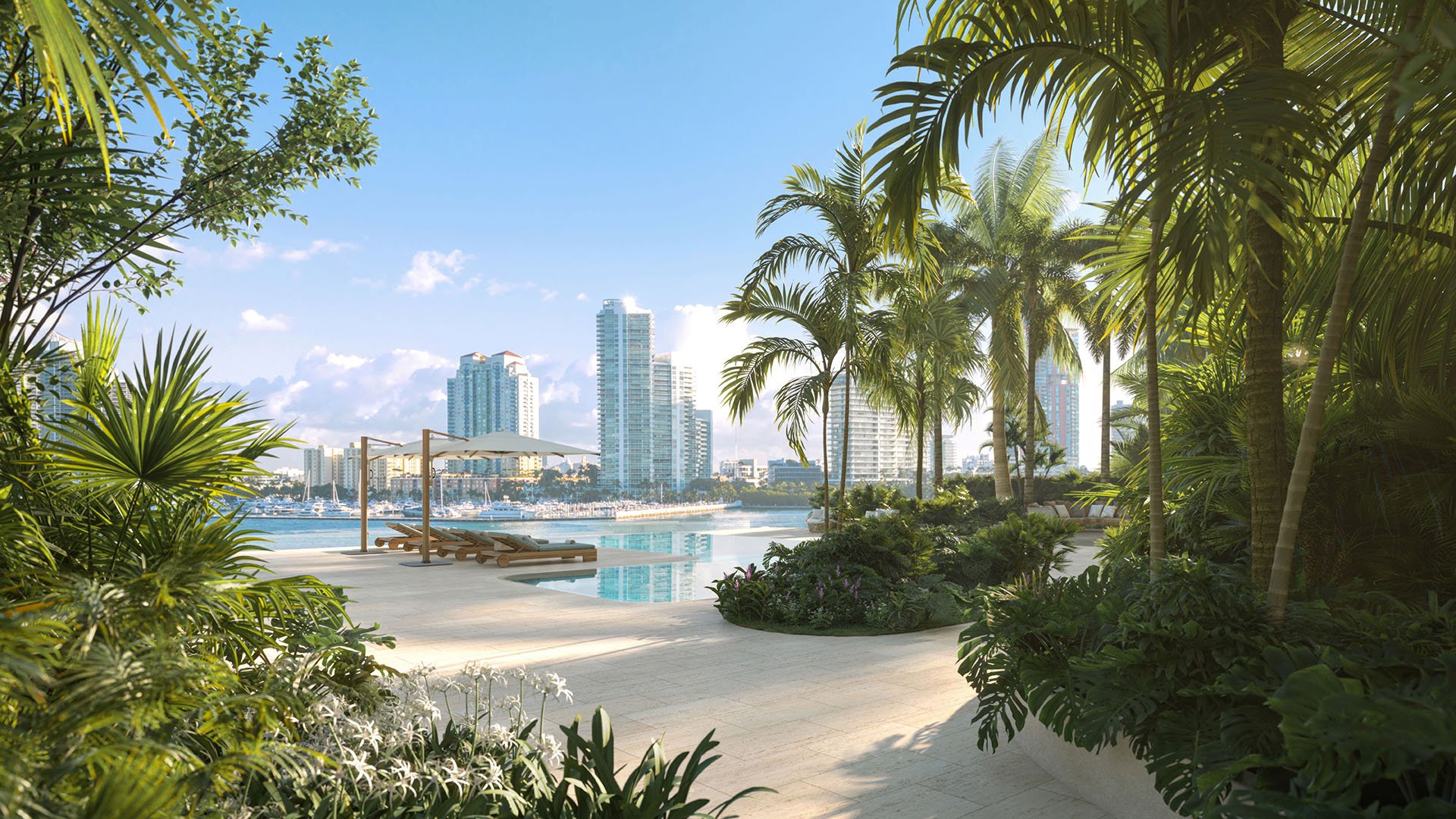 Villa terrace infinity pool at The Residences at Six Fisher Island, Fisher Island Miami Beach Florida, surrounded by lush tropical landscaping with Miami skyline beyond; luxury and ultra luxury preconstruction condos lifestyle.