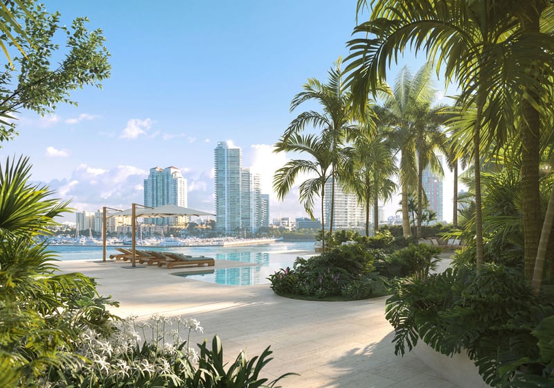 Villa terrace infinity pool at The Residences at Six Fisher Island, Fisher Island Miami Beach Florida, surrounded by lush tropical landscaping with Miami skyline beyond; luxury and ultra luxury preconstruction condos lifestyle.