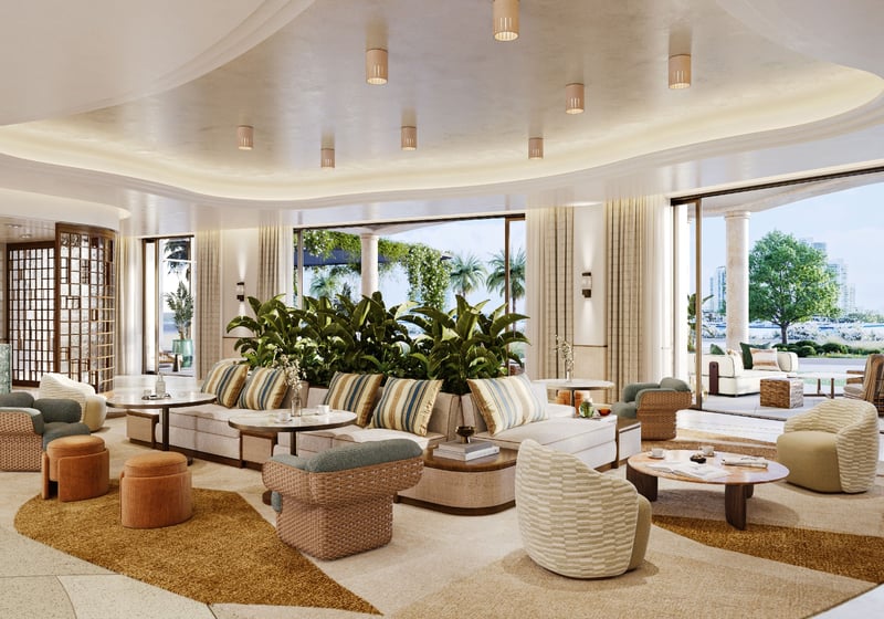 Waterfront gallery lounge at The Residences at Six Fisher Island, Fisher Island Miami Beach Florida, curved ceiling and designer seating opening to terrace; luxury and ultra luxury preconstruction condos social space.