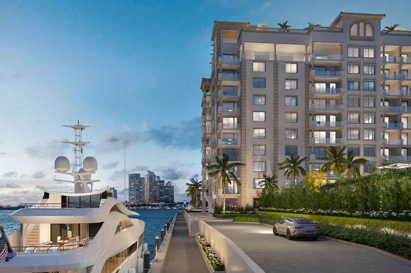 West Dock marina arrival at The Residences at Six Fisher Island, Fisher Island Miami Beach Florida, luxury condo exterior at dusk with yacht and waterfront drive; ultra luxury preconstruction condos on Biscayne Bay.